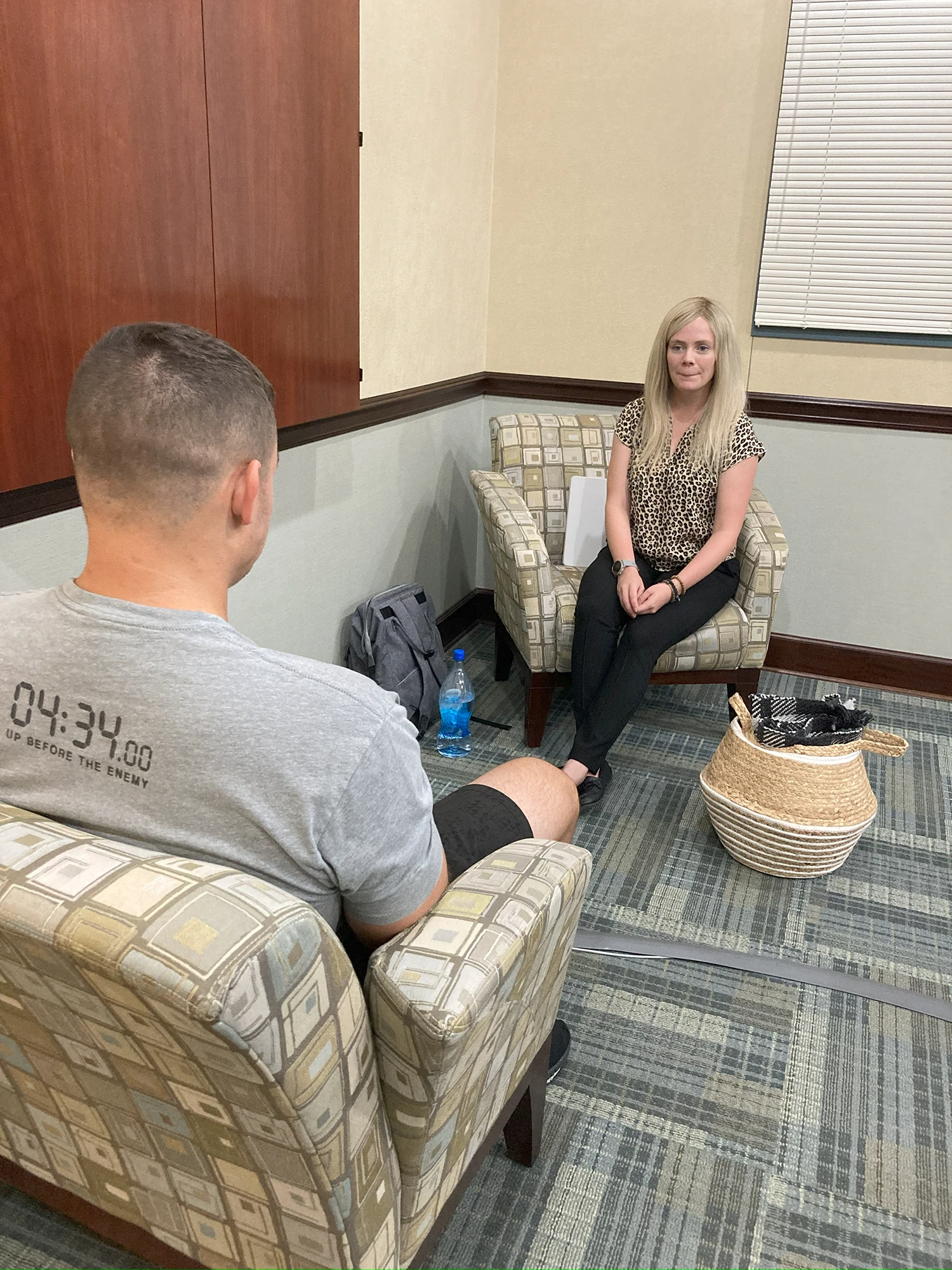 a man and woman sitting in a therapy session
